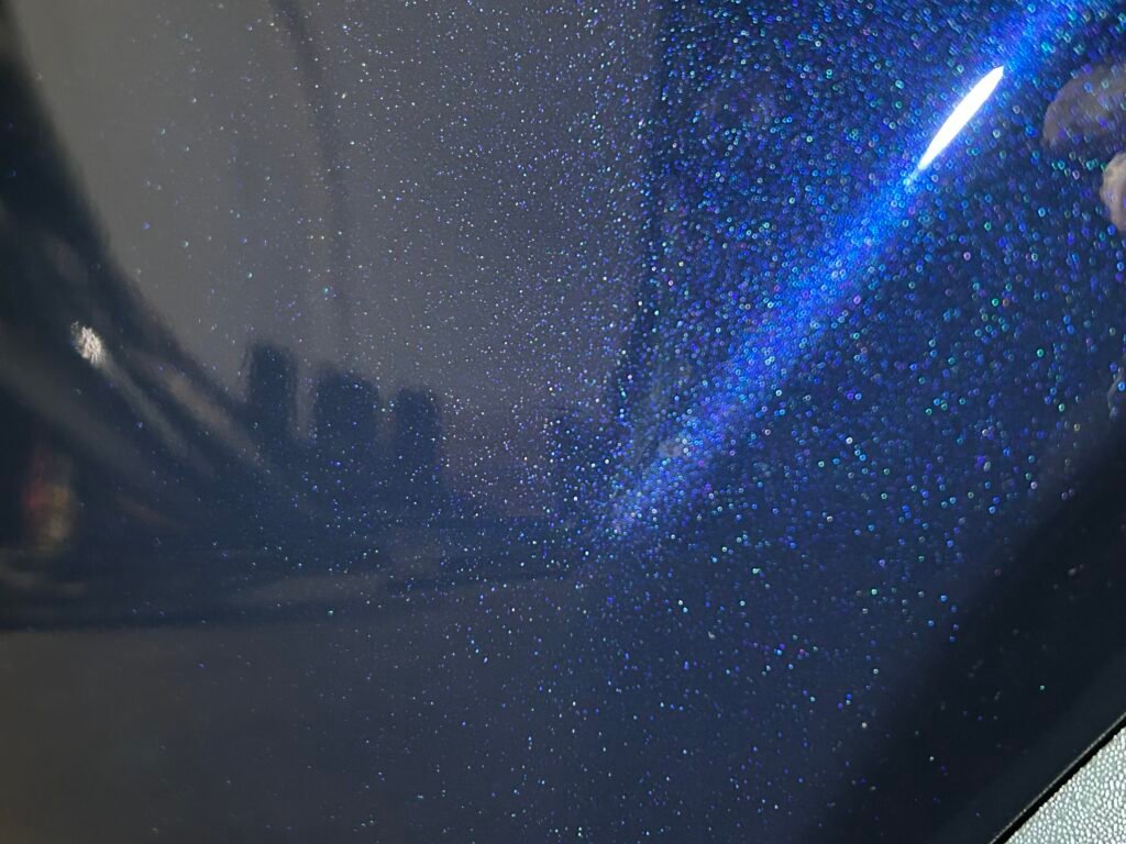 Close up of the area in which the scratch had existed, showing that the scratch has been repaired.