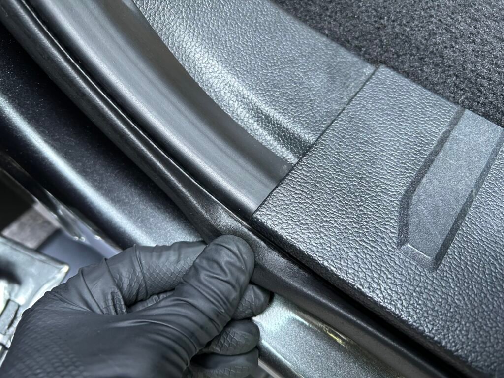 Close-up image of a vehicle's door jam seal. The seal is clean and looks brand new.